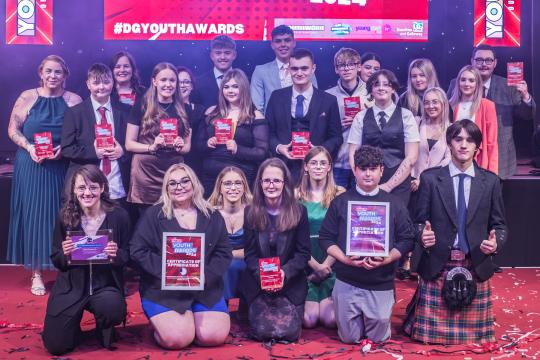 A group of people holding certificates