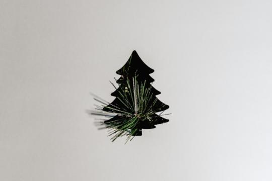 Black festive tree on white wall  